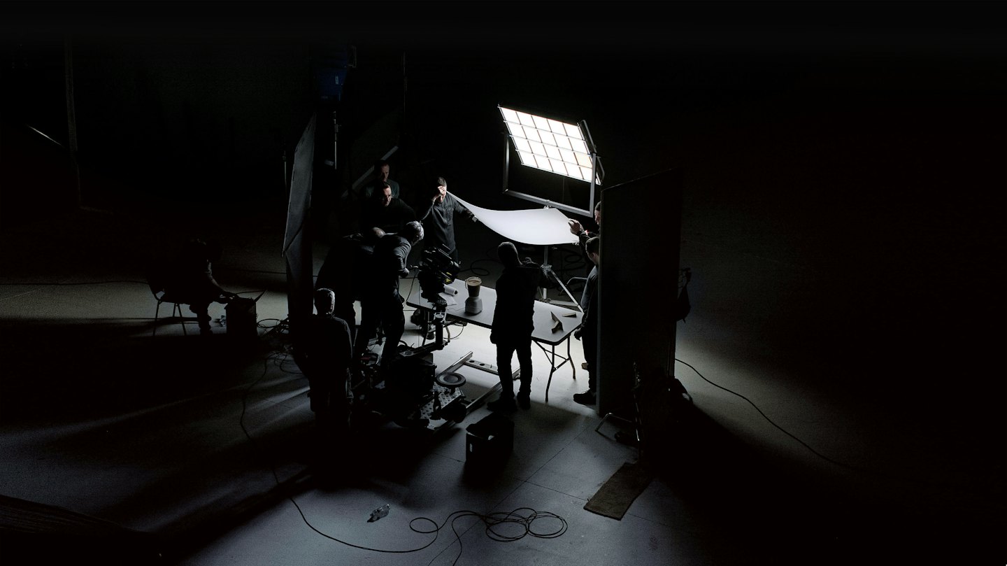 Production crew setting up a scene on a professional indoor set.
